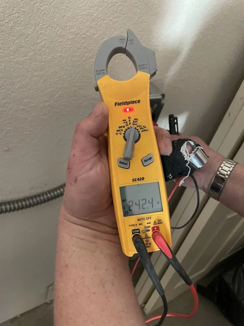 Voltage testing with clamp meter during Ceiling Fan Installation in Loves Park